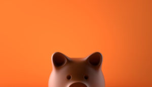 Piggy bank over orange background