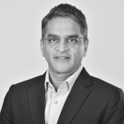 A speaker photo for Dhanpal Jhaveri