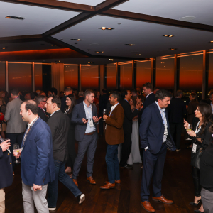 crowded room of professionals networking